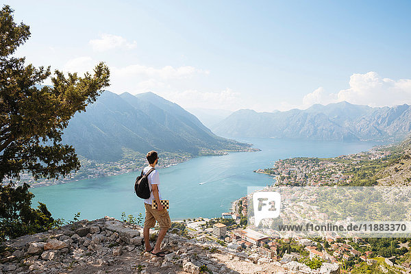 Hiker on mountain looking away at elevated view of sea  Kotor  Montenegro  Europe
