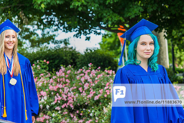 Two female students in graduation gowns