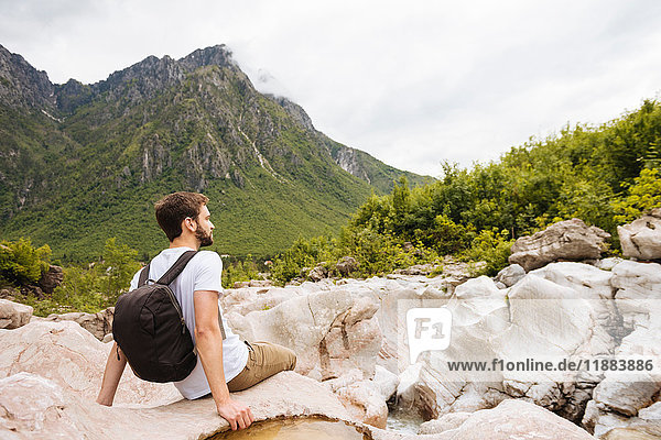 Man sitting on rocks looking away  Accursed mountains  Theth  Shkoder  Albania  Europe