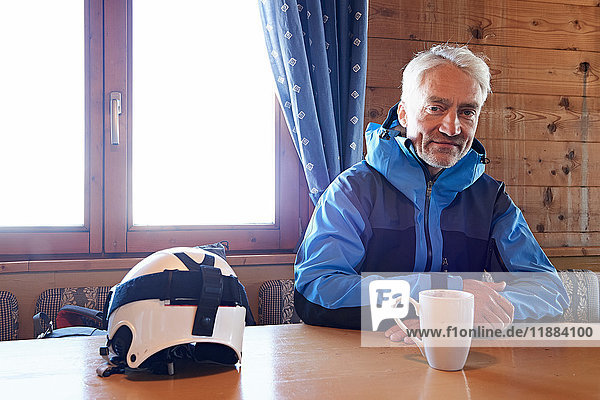 Man taking coffee break in log cabin  Hintertux  Tirol  Austria