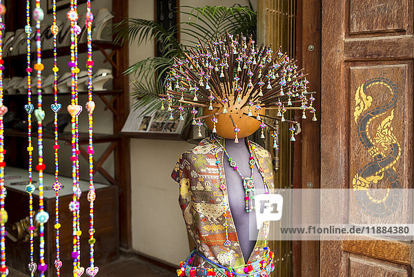 Eine Schaufensterpuppe mit traditioneller asiatischer Kleidung  Perlenschmuck und zahlreichen Stöcken mit Perlen  die aus dem Kopf herausragen; Luang Prabang  Provinz Luang Prabang  Laos