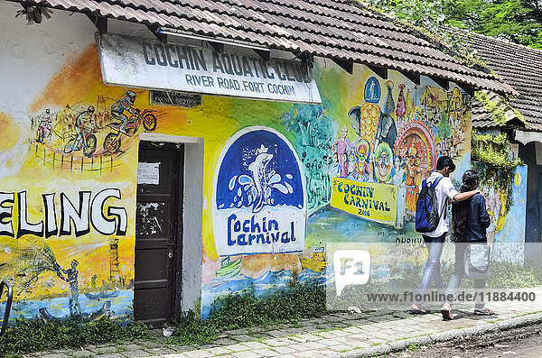 'Young Indian couple walking on River Road with murals  Fort Cochin; Kochi  Kerala  India'
