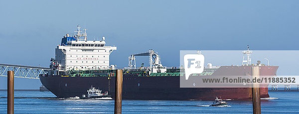 'A large ship travels up the Columbia River; Astoria  Oregon  United States of America'