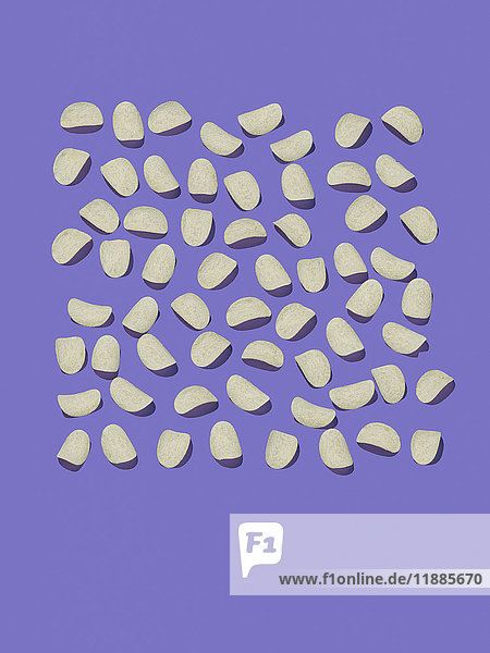 High angle view of potato chips on purple background