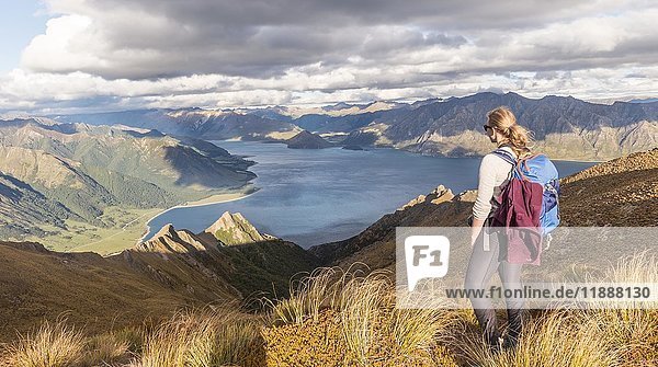 Female hiker looking at lake  Lake Hawea and mountain landscape  Isthmus Peak  Otago  South Island  New Zealand  Oceania