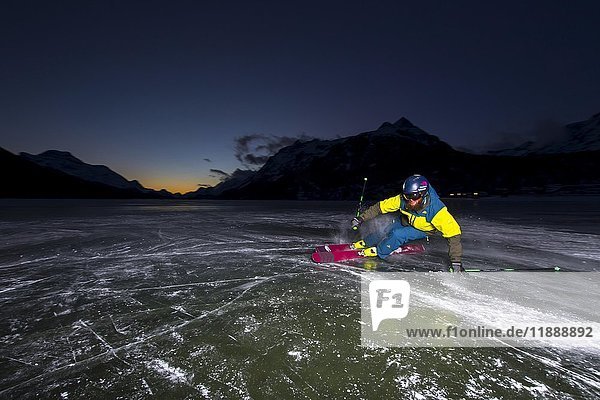 Skier on the ice  frozen Silvaplana lake  in the evening  Silvaplana lake  Silvaplana  Graubünden  Switzerland  Europe