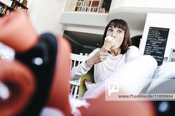 Woman wearing roller skates sitting in a cafe  eating icecream