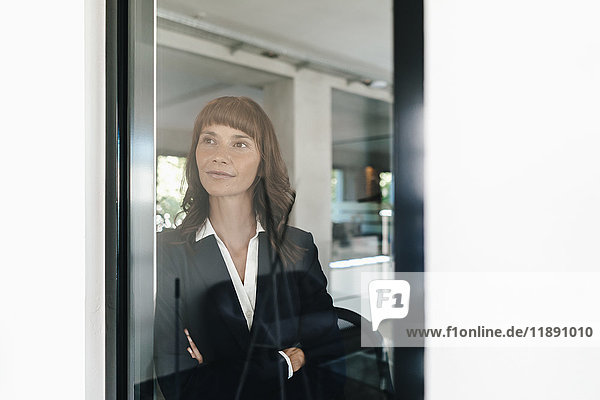 Confident businesswoman looking out of window