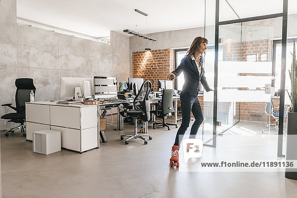 Successful businesswoman wearing roller skates in office