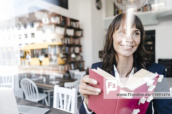 Businesswoman sitting cafe  reading book