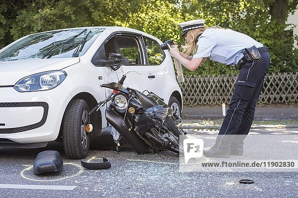 Heavy road accident  Simson scooter crashing in car  policewoman recording accident  Germany  Europe