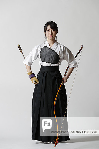 Japanese traditional archery athlete against white background
