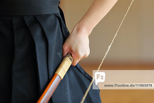 Japanese traditional archery athlete hand holding bow