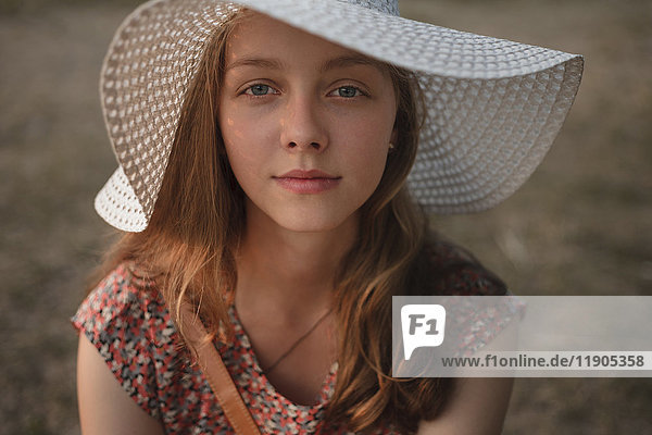 Portrait of Caucasian teenage girl wearing sun hat