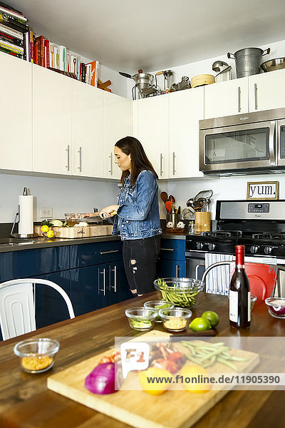 Woman chopping vegetables in kitchen