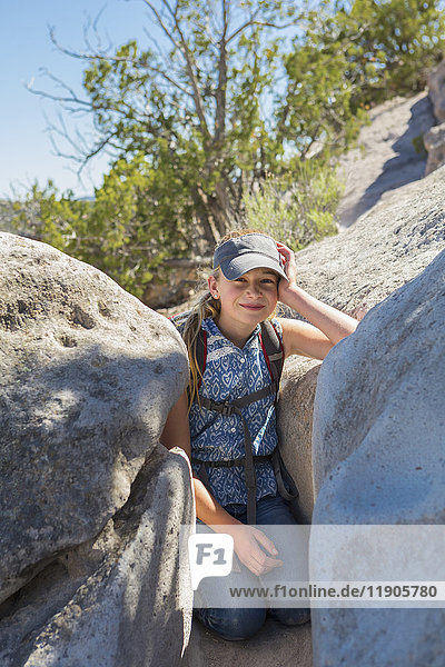 Portrait of Caucasian girl leaning on rock