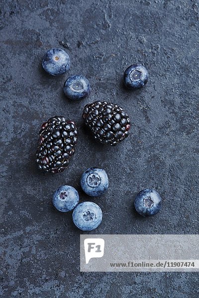 Blackberries and blueberries on a stone background