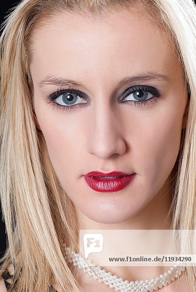 Close up portrait of a beautiful blond woman staring.