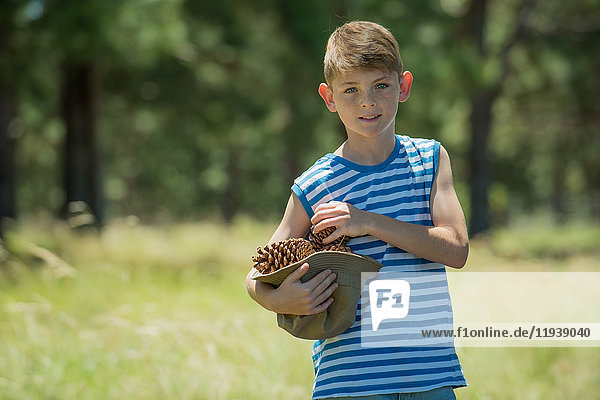 Boy carrying pinecones  portrait