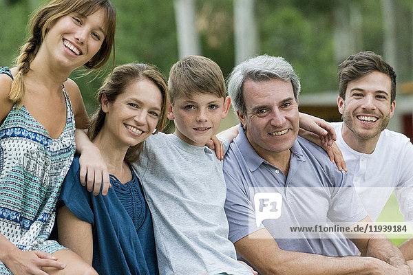 Family sitting together outdoors  portrait