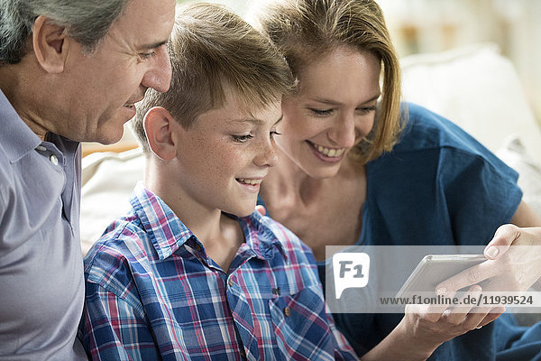 Family looking at smartphone together