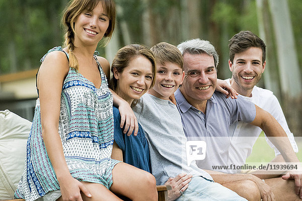 Family sitting together outdoors  portrait