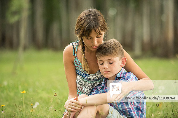 Mother comforting son outdoors