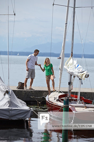 Germany  Bavaria  Lake Starnberg  couple at sailboat