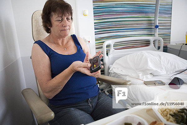 Reportage in a weekly hospitalization service in the endocrinology unit of a hospital in Savoie  France. Diabetic patients are hospitalized for a week to undergo an assessment on their diabetes: evolution of the diabetes  dietary habits and therapeutic education. A patient monitors her blood sugar level before a meal.