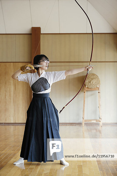 Japanese traditional Kyudo archery athlete practicing