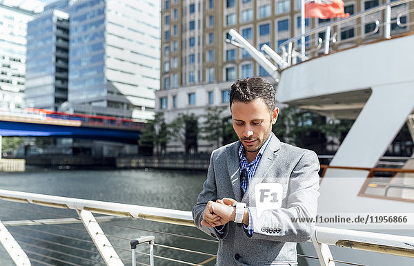 Businessman checking the time in the city