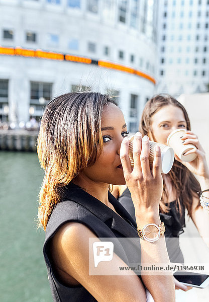 Two women having a coffee break in the city