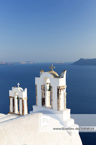 White church belltowers overlooking the Caldera Oia Santorini Cyclades Greek Islands Greece Europe