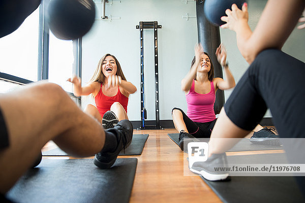 Freunde trainieren mit Medizinball im Fitnessstudio