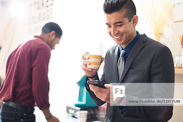 Young businessman looking at smartphone