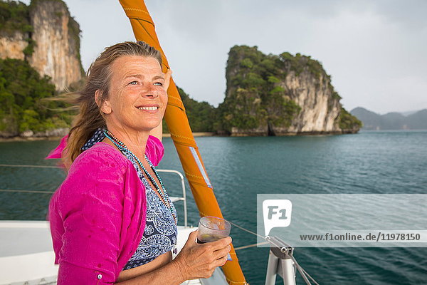 Woman sailing on yacht looking away smiling  Koh Hong  Thailand  Asia