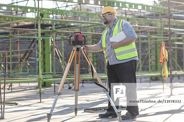Construction worker using surveying equipment