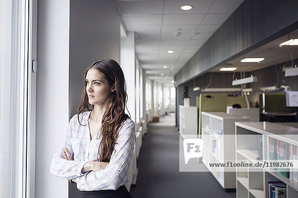 Female architect looking through window