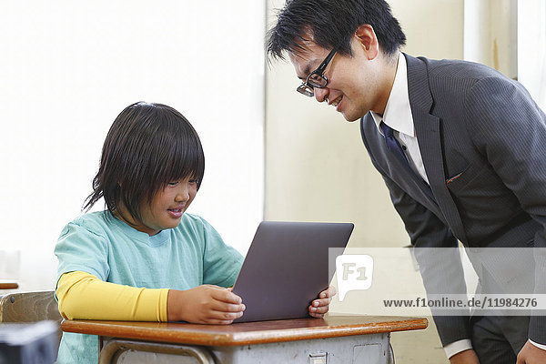 Japanese elementary school teacher teaching in the classroom