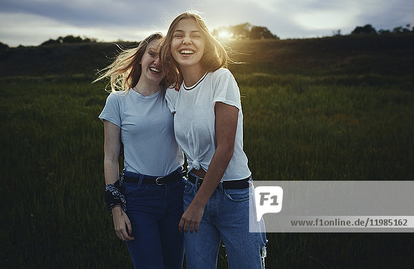 Portrait lächelnde  fröhliche Teenager-Schwestern im ländlichen Raum
