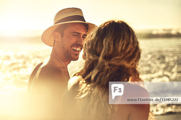 Laughing young couple on sunny summer beach