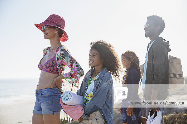 Multi-ethnic family standing on sunny summer beach