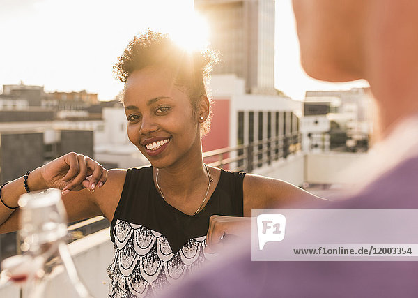 Portrait of smiling young woman on a rooftop party