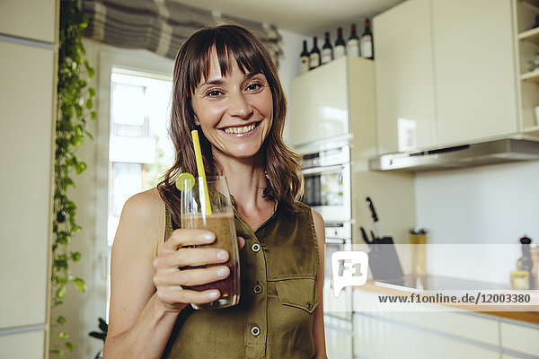 Woman holding her homemade smoothie