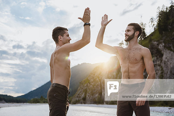 Germany  Bavaria  two best friends high fiving in nature