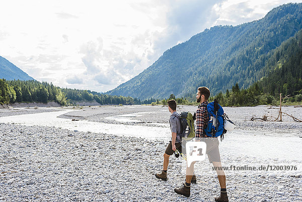 Germany  Bavaria  two hikers walking in dry creek bed