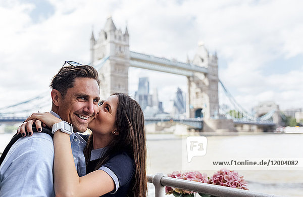 UK  London  happy couple kissing with the Tower Bridge in the background