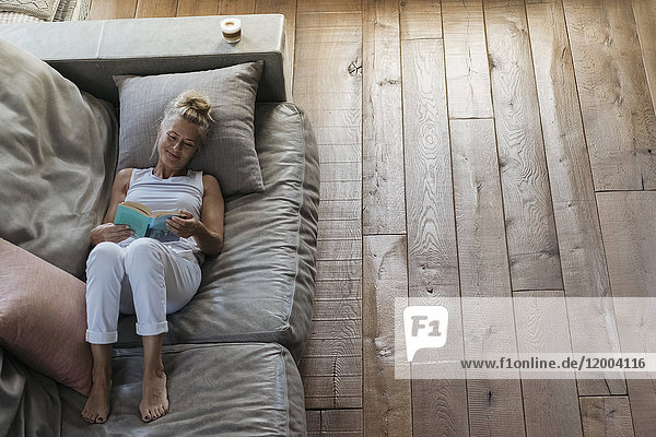 Woman relaxing on couch  reading book
