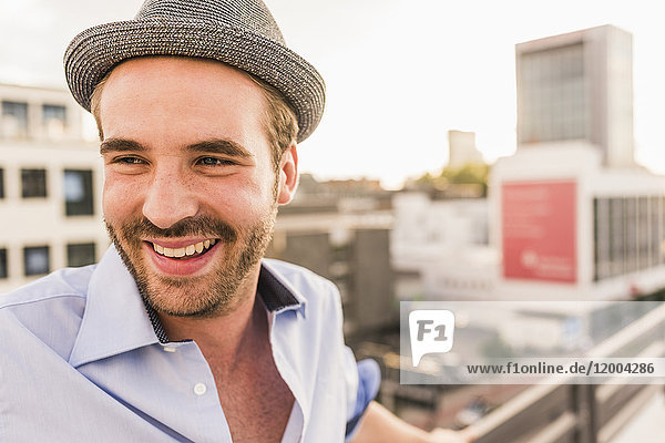 Portrait of happy young man on rooftop