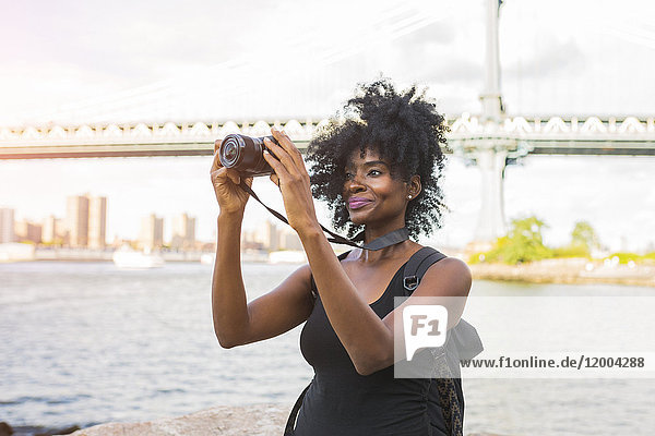 USA  New York City  Brooklyn  woman looking at camera at the waterfront